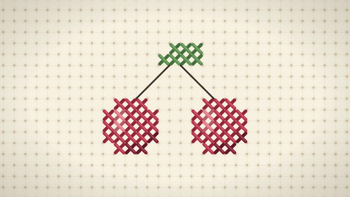 Pair of cross stitched red cherries with backstitched stems and a green leaf on cream Aida